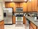 Modern kitchen with stainless steel appliances, granite countertops, and updated cabinetry at 507 Madison Se Ct, Smyrna, GA 30080