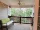 Inviting covered porch with a comfortable bench, string lights and a peaceful view of the surrounding greenery at 507 Madison Se Ct, Smyrna, GA 30080