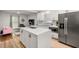 Modern kitchen featuring stainless steel appliances, a center island, and an open view into the adjacent living area at 2612 Clairmont Ne Rd, Atlanta, GA 30329