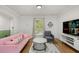 Comfortable living room with a pink sofa, modern decor, and an open layout leading to other areas of the home at 2612 Clairmont Ne Rd, Atlanta, GA 30329
