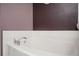 Close up of a white bathtub with chrome fixtures and white tile surround at 4743 Longcourt Se Dr, Atlanta, GA 30339