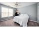 Cozy bedroom featuring a ceiling fan, window, and a bed with white linens for a restful retreat at 4743 Longcourt Se Dr, Atlanta, GA 30339