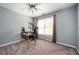 Carpeted bedroom featuring a window, ceiling fan, and desk area at 4743 Longcourt Se Dr, Atlanta, GA 30339