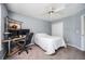 Bedroom with a small bed, a ceiling fan, and a desk with dual monitors at 4743 Longcourt Se Dr, Atlanta, GA 30339