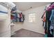 Walk-in closet with white wire shelving and clothing racks with a window for natural light at 4743 Longcourt Se Dr, Atlanta, GA 30339