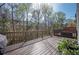 Large wooden deck with lush forest views, featuring wood railing and space for patio furniture at 4743 Longcourt Se Dr, Atlanta, GA 30339
