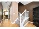 Inviting home entryway with hardwood floors, neutral paint, staircase, and closet, leading into a cozy living space at 4743 Longcourt Se Dr, Atlanta, GA 30339