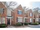 Charming brick townhome featuring a welcoming entryway, classic architecture, and well-maintained landscaping at 4743 Longcourt Se Dr, Atlanta, GA 30339