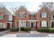 Charming brick townhomes line the street, with well-maintained landscaping at 4743 Longcourt Se Dr, Atlanta, GA 30339