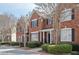 Brick townhome with manicured landscaping enhances its curb appeal at 4743 Longcourt Se Dr, Atlanta, GA 30339