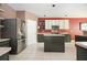 Spacious kitchen with stainless steel appliances, center island, dark cabinetry, and tiled flooring at 4743 Longcourt Se Dr, Atlanta, GA 30339