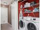 Organized laundry room boasts a washer, dryer, shelving, and a sliding barn door at 4743 Longcourt Se Dr, Atlanta, GA 30339