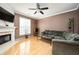 Bright living room with a corner fireplace, large windows, and hardwood floors at 4743 Longcourt Se Dr, Atlanta, GA 30339