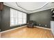 Comfortable living room with large window for natural light, hardwood floors, and built-in shelving with modern decor at 4743 Longcourt Se Dr, Atlanta, GA 30339