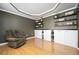 Comfortable living room featuring hardwood floors, built-in shelving, storage cabinets, and stylish modern décor at 4743 Longcourt Se Dr, Atlanta, GA 30339