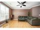 Cozy living room with light-colored hardwood floors, a sofa, and a ceiling fan at 4743 Longcourt Se Dr, Atlanta, GA 30339