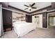 Main bedroom with a king-size bed, a wood-accented wall, and a ceiling fan at 4743 Longcourt Se Dr, Atlanta, GA 30339