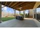 Covered patio with hot tub, fan, and view of the fenced backyard at 722 Laurel Canyon Pkwy, Canton, GA 30114