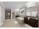 A luxurious bathroom featuring a soaking tub, glass shower, granite counters and tile floors at 722 Laurel Canyon Pkwy, Canton, GA 30114