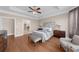 Bedroom featuring hardwood floors, tray ceilings, neutral walls and decor, and furniture at 722 Laurel Canyon Pkwy, Canton, GA 30114