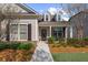 Cozy covered porch with decorative pillars, stone accents, and a well maintained lawn at 722 Laurel Canyon Pkwy, Canton, GA 30114