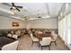 Well-lit game room featuring multiple tables, ceiling fans, neutral color scheme, and wall-mounted television at 722 Laurel Canyon Pkwy, Canton, GA 30114