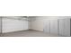 Spacious two car garage with white walls and floor cabinets for storage at 722 Laurel Canyon Pkwy, Canton, GA 30114