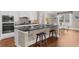 Modern kitchen with granite island, stainless appliances, pendant lighting, and breakfast area at 722 Laurel Canyon Pkwy, Canton, GA 30114