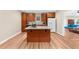 Kitchen with wood cabinets, granite countertops, an island and a view into the living room at 722 Laurel Canyon Pkwy, Canton, GA 30114