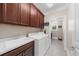 Well-lit laundry room with washer, dryer, and storage cabinets at 722 Laurel Canyon Pkwy, Canton, GA 30114