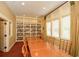 Library room with built-in shelving, long table, and sun-filled windows at 722 Laurel Canyon Pkwy, Canton, GA 30114
