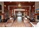 Symmetrical lobby with a grand fireplace and bookshelves leading to the entrance, creating a balanced and elegant space at 722 Laurel Canyon Pkwy, Canton, GA 30114