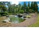Picturesque pond with small waterfalls and the community's Soleil sign, surrounded by lush greenery at 722 Laurel Canyon Pkwy, Canton, GA 30114
