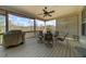 Covered porch featuring a ceiling fan, dining table and chairs overlooking the wooded scenery at 722 Laurel Canyon Pkwy, Canton, GA 30114