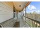 Covered porch with a cozy cushioned bench, side table, and scenic views for relaxing at 722 Laurel Canyon Pkwy, Canton, GA 30114