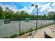 Well-lit community tennis courts with benches for players and a green surface at 722 Laurel Canyon Pkwy, Canton, GA 30114