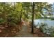 Scenic walking trail lined with lush trees and foliage offering serene views of the adjacent lake at 722 Laurel Canyon Pkwy, Canton, GA 30114