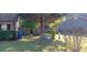Fenced backyard with lush greenery, shrubs, and trees for privacy and outdoor enjoyment at 8219 Canyon Forge Dr, Riverdale, GA 30274
