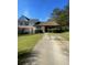 Inviting two-story home featuring a well-maintained front lawn and a paved driveway at 8219 Canyon Forge Dr, Riverdale, GA 30274