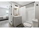 Bathroom featuring a shower with a white shower curtain, grey vanity, and matte black fixtures at 119 Old Vandiver Dr, Canton, GA 30114