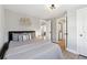Bedroom featuring a cushioned headboard, calming decor and a view to an adjacent Laundry Room at 119 Old Vandiver Dr, Canton, GA 30114