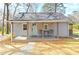 Charming home featuring a covered porch, light-blue front door, and neutral siding, set on a tree-lined lot at 119 Old Vandiver Dr, Canton, GA 30114