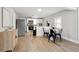Well-lit kitchen with stainless steel appliances, white cabinets, and modern dining area at 119 Old Vandiver Dr, Canton, GA 30114