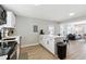 Open-concept kitchen with island, white cabinetry, and stainless steel appliances at 119 Old Vandiver Dr, Canton, GA 30114