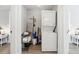 A well-organized laundry area with stackable washer and dryer, shelves, and cleaning supplies at 119 Old Vandiver Dr, Canton, GA 30114