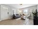 Cozy living room featuring a modern sofa, stylish decor, and great natural light through the windows at 119 Old Vandiver Dr, Canton, GA 30114
