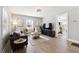 Comfortable living room with hardwood floors, large windows, and seamless access to other rooms at 119 Old Vandiver Dr, Canton, GA 30114