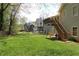 Spacious backyard with lush green grass and a view of the elevated wood deck at 2562 Kennesaw Springs Nw Ct, Kennesaw, GA 30144