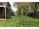 Expansive backyard featuring a well-maintained lawn, storage shed, and partial fencing for outdoor enjoyment at 2562 Kennesaw Springs Nw Ct, Kennesaw, GA 30144