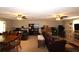 Finished basement with a cozy seating area, built-in shelving, and two ceiling fans at 2562 Kennesaw Springs Nw Ct, Kennesaw, GA 30144